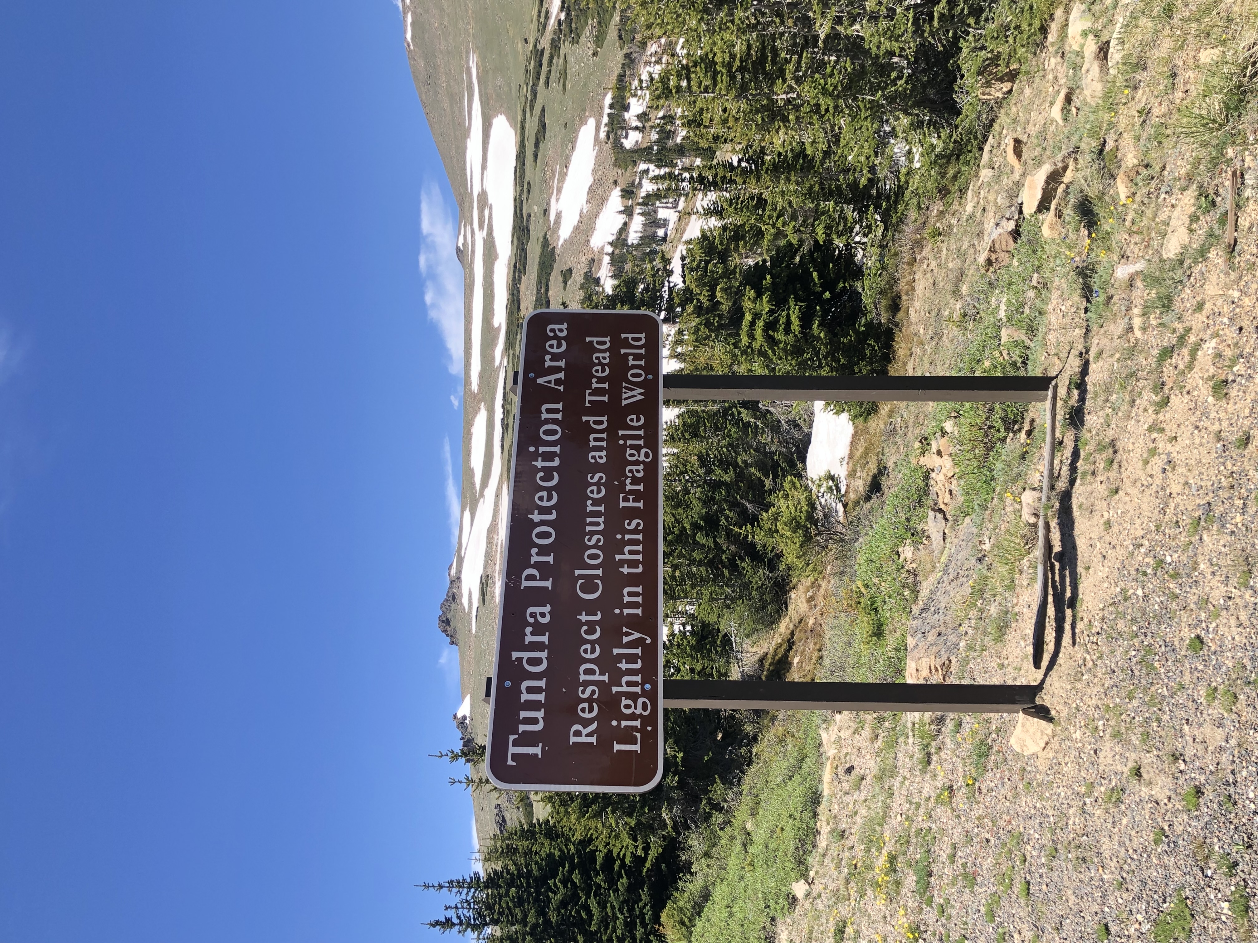 Sign in Rocky Mountain National Park reading 'Tundra Protection Area: Respect Closures and Tread Lightly in this Fragile World'